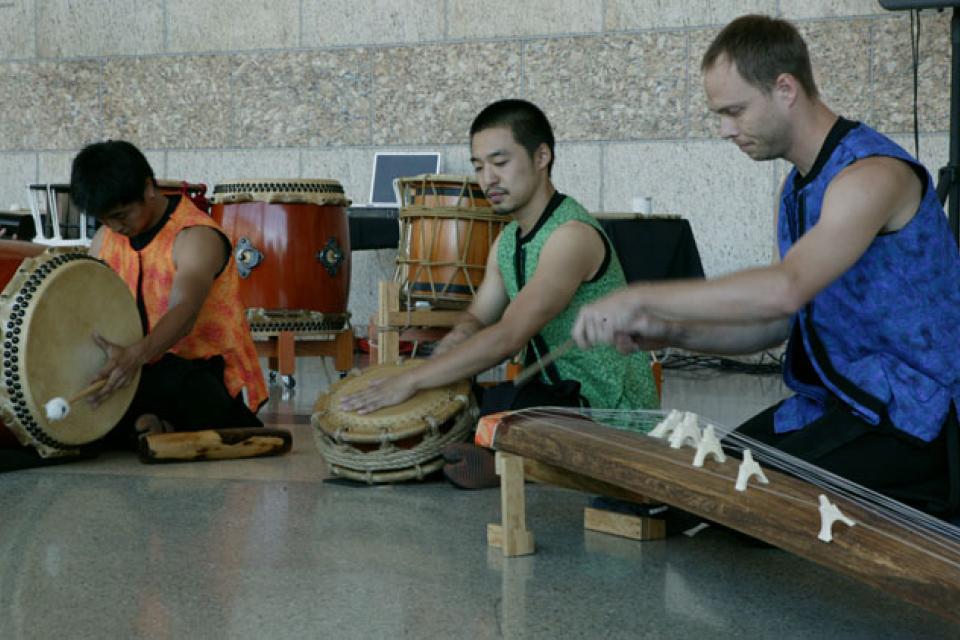 Three members from On Ensemble perform drums
